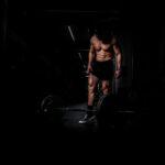 woman in black tank top and red shorts doing exercise