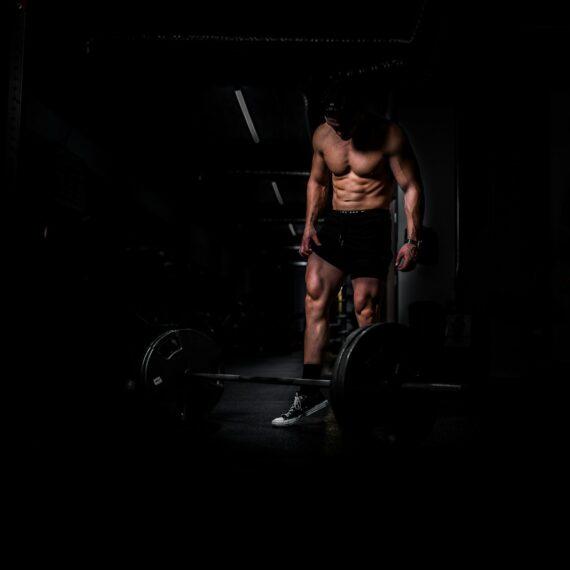 woman in black tank top and red shorts doing exercise