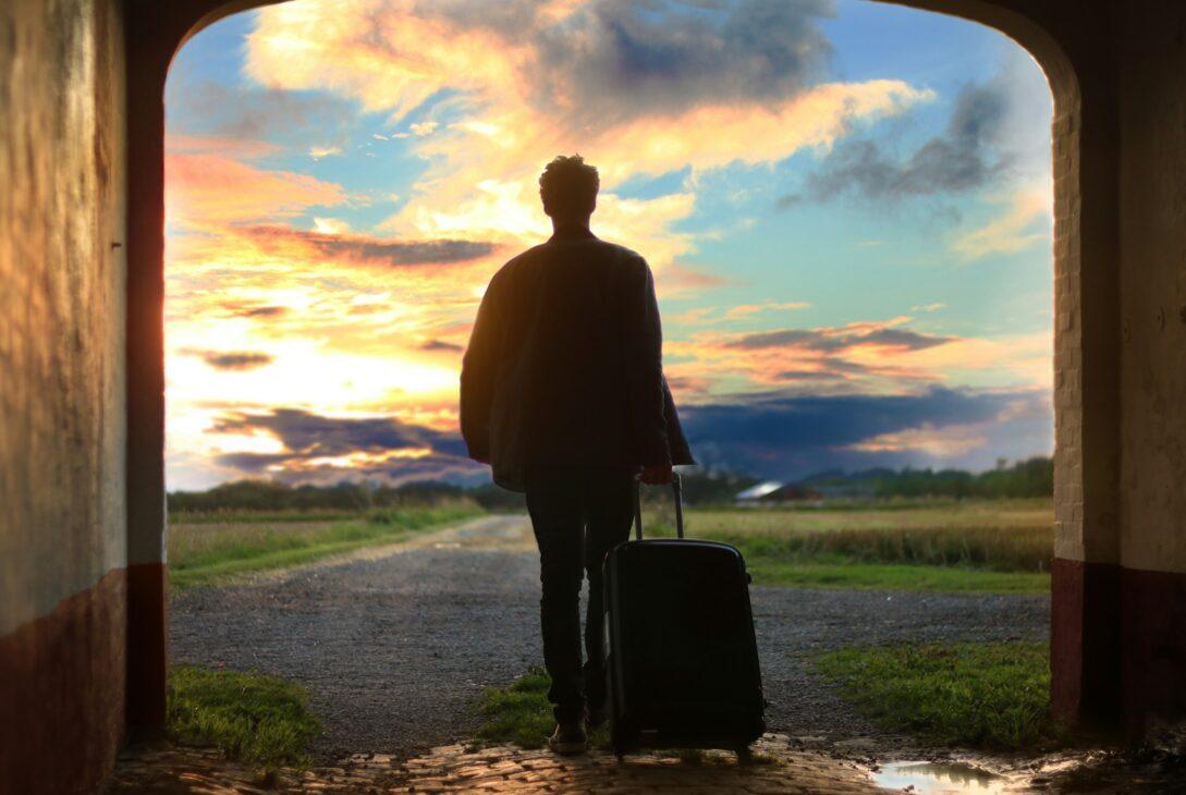 man holding luggage photo