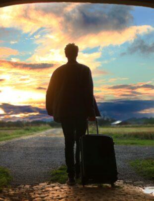 man holding luggage photo