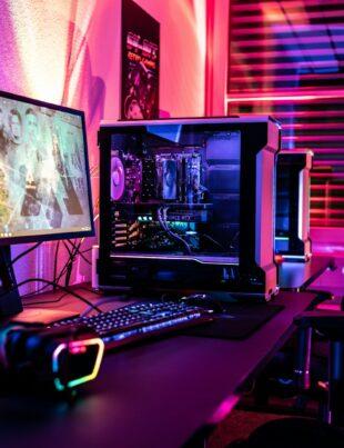a computer desk with a monitor, keyboard and mouse