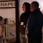 a group of men standing in a room