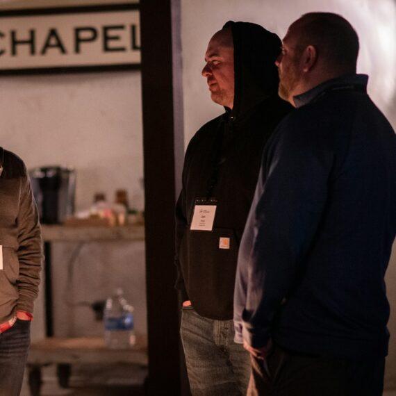 a group of men standing in a room