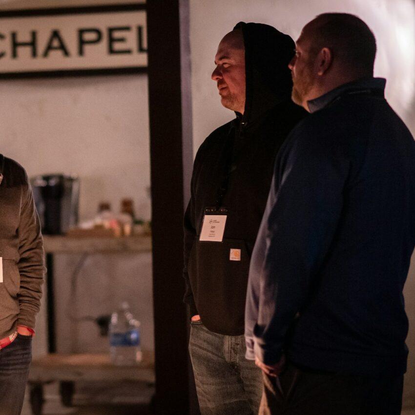 a group of men standing in a room