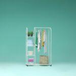 a rack with clothes and a hat on it