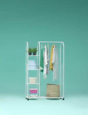 a rack with clothes and a hat on it