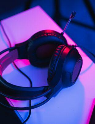 black and red corded headphones on white table