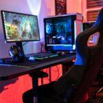 a desk with a computer and a gaming chair