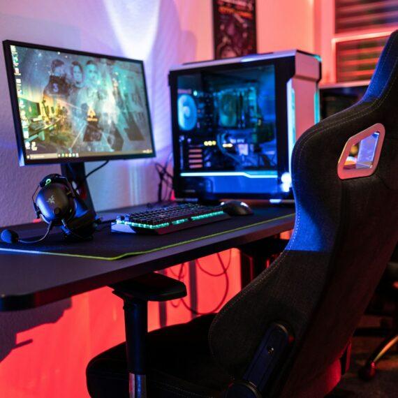 a desk with a computer and a gaming chair